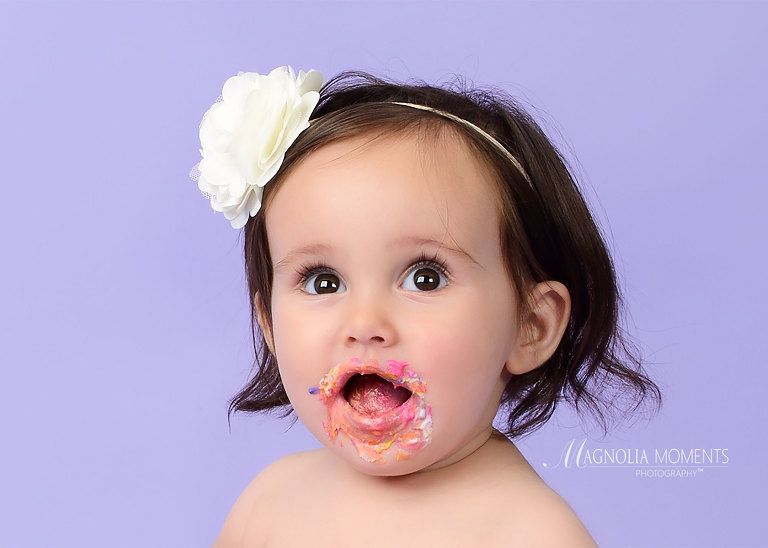 Close up of baby girl on lavender during her cake smash session by Evan Pollock of Magnolia Moments Photography