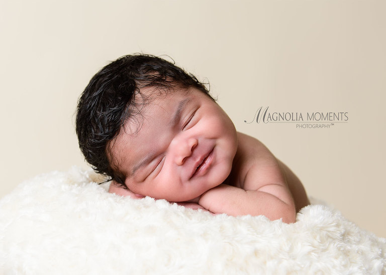 Precious dark haired newborn girl on white photographed by Evan Pollock of Magnolia Moments Photography one of the photography studios near me
