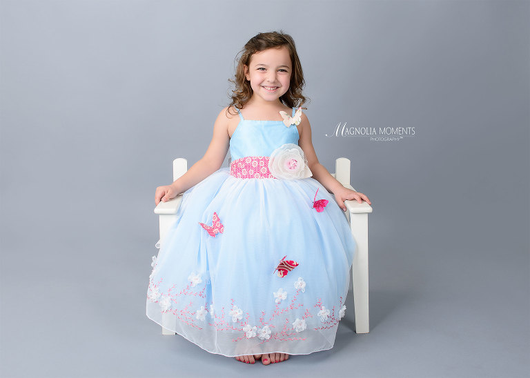 4 year old birthday girl in beautiful blue dress photographed during her child photography session by Evan Pollock of Magnolia Moments Photography. Collegeville child photographer.